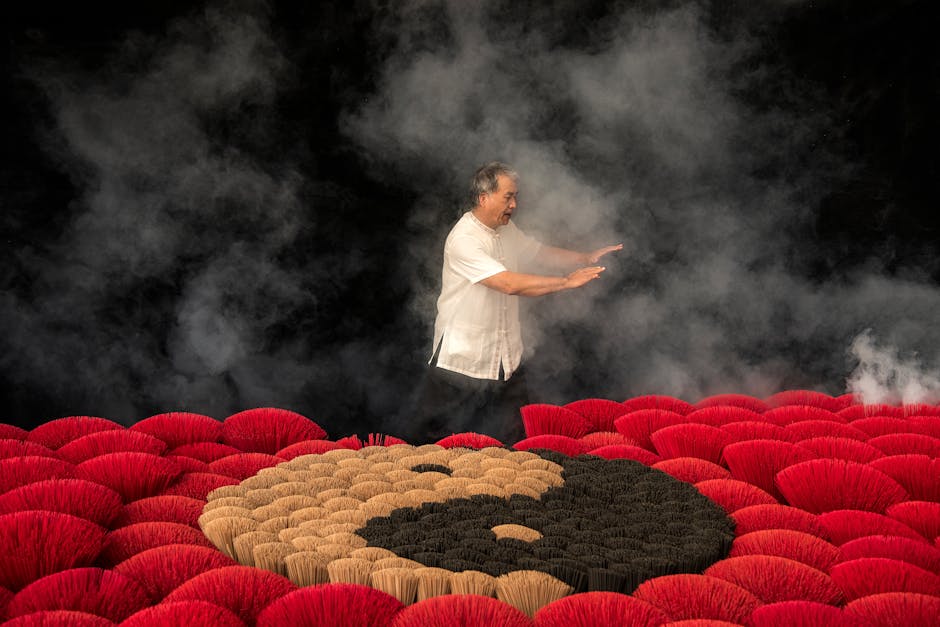 Adult practicing Tai Chi surrounded by incense with Yin Yang symbol and smoky atmosphere.